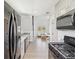 Modern kitchen and living space with stainless steel appliances and gray cabinets at 6679 Wander Ln, New Port Richey, FL 34652