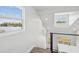 Landing at the top of the stairs featuring views of a lake through three windows at 6679 Wander Ln, New Port Richey, FL 34652