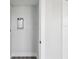 Laundry room with white walls, gray wood floors, a utility sink, and closet at 6679 Wander Ln, New Port Richey, FL 34652