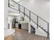 Open concept living space with stairs to loft, kitchen, dining, and bright natural light at 6679 Wander Ln, New Port Richey, FL 34652