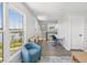 Sitting area with wood floors, a blue chair and views of a lake and green foliage at 6679 Wander Ln, New Port Richey, FL 34652