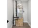 Utility closet containing the furnace, duct work and plumbing with wood floor and white trim at 6679 Wander Ln, New Port Richey, FL 34652