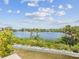 Scenic view of a serene body of water surrounded by lush greenery and clear blue skies at 6679 Wander Ln, New Port Richey, FL 34652
