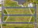 Aerial view showcasing green home lots along a water inlet with neighborhood and houses nearby at 6707 Wander Ln, New Port Richey, FL 34654
