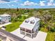 A charming two-story home with a metal roof, surrounded by lush greenery in a desirable neighborhood at 6707 Wander Ln, New Port Richey, FL 34654