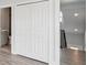 Second floor hallway with closet and bathroom view with modern railing and luxury vinyl flooring at 6707 Wander Ln, New Port Richey, FL 34654