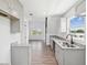 Inviting kitchen with stainless sink, gray cabinets, granite counters, and wood-look flooring at 6707 Wander Ln, New Port Richey, FL 34654