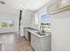 Updated kitchen featuring modern gray cabinets, granite counters, and views to a bright living space at 6707 Wander Ln, New Port Richey, FL 34654