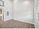 Bright living room with tall ceilings, wood-look flooring, and abundant natural light at 6707 Wander Ln, New Port Richey, FL 34654