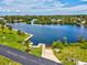 Aerial view of waterfront property featuring boat ramp and neighborhood at 6715 Wander Ln, New Port Richey, FL 34654
