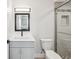 Modern bathroom featuring sleek vanity, elegant mirror, and tiled shower at 6715 Wander Ln, New Port Richey, FL 34654