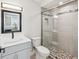 Well-lit bathroom with a glass shower, modern fixtures, and tiled floor at 6715 Wander Ln, New Port Richey, FL 34654