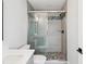 Bathroom features a modern glass enclosed tile shower with decorative tile accents and stylish fixtures at 6715 Wander Ln, New Port Richey, FL 34654