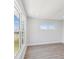 Bright room with a large window that lets in lots of natural light and wood-look flooring at 6715 Wander Ln, New Port Richey, FL 34654