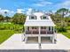 Charming raised home with a metal roof and a spacious ground-level parking and entertaining area at 6715 Wander Ln, New Port Richey, FL 34654