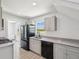 Bright kitchen features stainless appliances, stylish cabinets, granite counters and backsplash at 6715 Wander Ln, New Port Richey, FL 34654