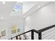 Bright staircase featuring modern railing, large windows, and plenty of light at 6715 Wander Ln, New Port Richey, FL 34654