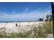 Scenic beach view showcasing white sand, clear blue sky, and a high-rise building in the distance at 6800 Sunset Way # 1708, St Pete Beach, FL 33706