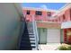 Exterior view of building with stairwell leading up to units at 6800 Sunset Way # 1708, St Pete Beach, FL 33706