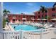 Inviting swimming pool surrounded by lounge chairs and lush landscaping, perfect for relaxation at 6800 Sunset Way # 1708, St Pete Beach, FL 33706