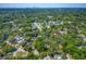 Expansive aerial view of a lush, green neighborhood close to a city skyline, marked with a pinpoint location indicator at 6806 N 17Th St, Tampa, FL 33610