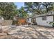 Large backyard with a patio area, outdoor grill, and privacy fence, creating a perfect space for outdoor living at 6806 N 17Th St, Tampa, FL 33610