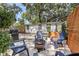 Backyard patio area featuring a fire pit, grill, lush greenery, and comfortable seating perfect for entertaining at 6806 N 17Th St, Tampa, FL 33610