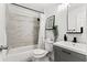 Modern bathroom with a tiled shower, gray vanity, and stylish fixtures at 6806 N 17Th St, Tampa, FL 33610