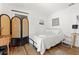 Bright and airy bedroom with a decorative screen and hardwood floors at 6806 N 17Th St, Tampa, FL 33610
