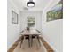 Bright dining room featuring a long wooden table with seating for eight and a large window at 6806 N 17Th St, Tampa, FL 33610