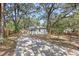 Charming single-story house with a long driveway, surrounded by mature trees providing ample shade at 6806 N 17Th St, Tampa, FL 33610