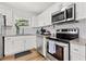 Well-equipped kitchen with stainless steel appliances, granite counters, and white subway tile backsplash at 6806 N 17Th St, Tampa, FL 33610