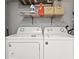 Efficient laundry area with modern washer, dryer, shelving, and storage baskets for organized convenience at 6806 N 17Th St, Tampa, FL 33610