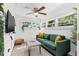 Cozy living room with a comfortable green sofa, soft rug, and plenty of natural light at 6806 N 17Th St, Tampa, FL 33610