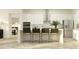 Modern kitchen island with white countertops, barstool seating, stainless steel appliances, and recessed lighting at 6830 E 115Th St, Palmetto, FL 34221