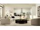 Open concept living room with a modern sofa, kitchen island with barstools, and stainless steel appliances at 6830 E 115Th St, Palmetto, FL 34221