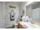 This bathroom has a toilet, vanity and mirror and is decorated with wall art and plants at 6925 Marble Fawn Pl, Riverview, FL 33578