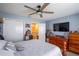 This bedroom has a queen-sized bed, a dresser, closet, wood furniture and a ceiling fan at 6925 Marble Fawn Pl, Riverview, FL 33578