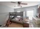 This bedroom has a bunk bed, a dresser and two windows letting in natural light at 6925 Marble Fawn Pl, Riverview, FL 33578