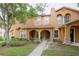 Exterior view of a two-story townhome with manicured front lawn and welcoming entrance at 6925 Marble Fawn Pl, Riverview, FL 33578