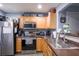 This kitchen features stainless steel appliances, wood cabinets and a stainless steel sink and faucet at 6925 Marble Fawn Pl, Riverview, FL 33578