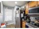 Well-lit kitchen with stainless steel refrigerator and modern appliances at 6925 Marble Fawn Pl, Riverview, FL 33578