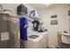 This laundry room has a washer and dryer, hot water heater and storage at 6925 Marble Fawn Pl, Riverview, FL 33578
