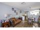 Open-concept room with hardwood floors, a sofa, a dining table and chairs at 6925 Marble Fawn Pl, Riverview, FL 33578
