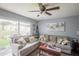 Bright living room with large window, comfortable seating, and stylish decor at 6925 Marble Fawn Pl, Riverview, FL 33578