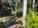 Tranquil backyard with lush tropical foliage creates a private outdoor oasis at 715 Riverside Dr, Tarpon Springs, FL 34689