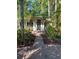 Inviting home entrance with a brick path and tropical landscaping provides curb appeal at 715 Riverside Dr, Tarpon Springs, FL 34689