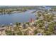 Waterfront property featuring a private pool, dock, and boat lift with lush landscaping at 739 Chesapeake Dr, Tarpon Springs, FL 34689