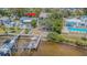 Beautiful waterfront property with dock and boat lift, surrounded by lush landscaping and mature trees at 739 Chesapeake Dr, Tarpon Springs, FL 34689