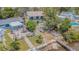 Two-story home with waterfront access, backyard patio, and lush landscaping, offering serene outdoor living at 739 Chesapeake Dr, Tarpon Springs, FL 34689